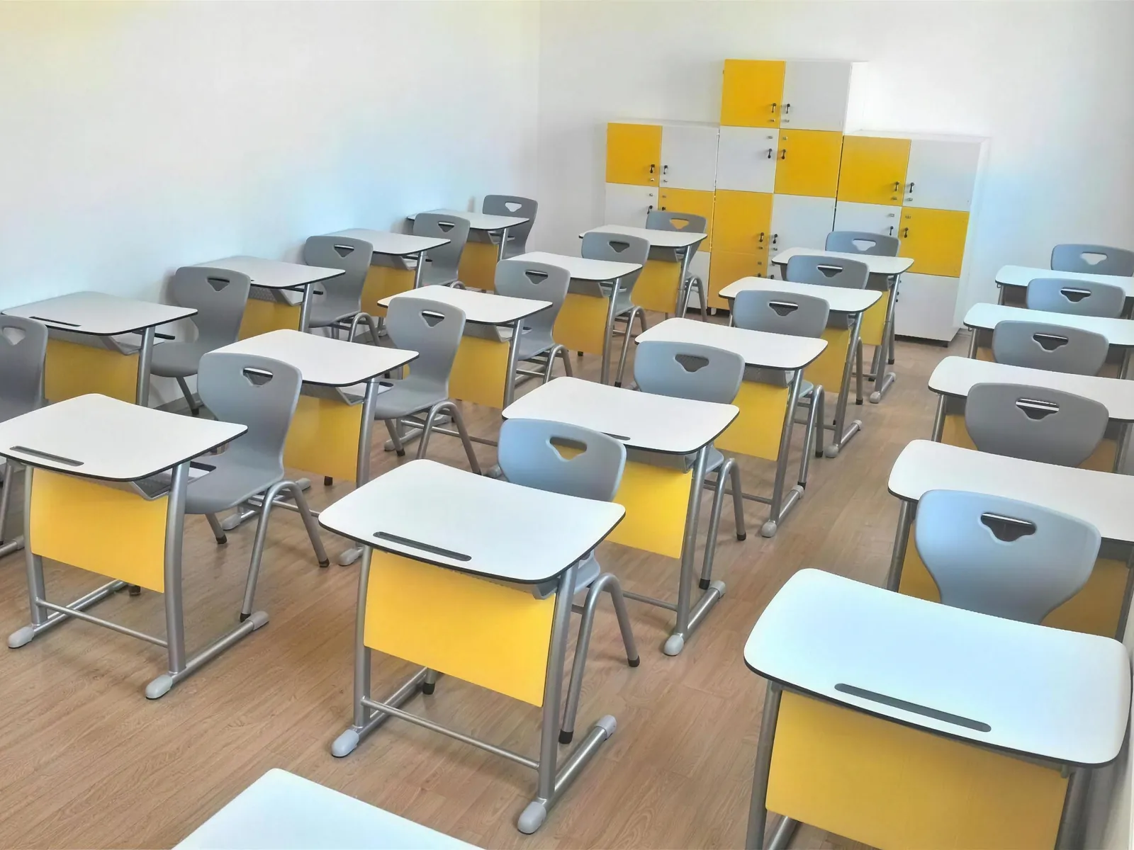 Classroom fitted with yellow-panelled student desks and lockers